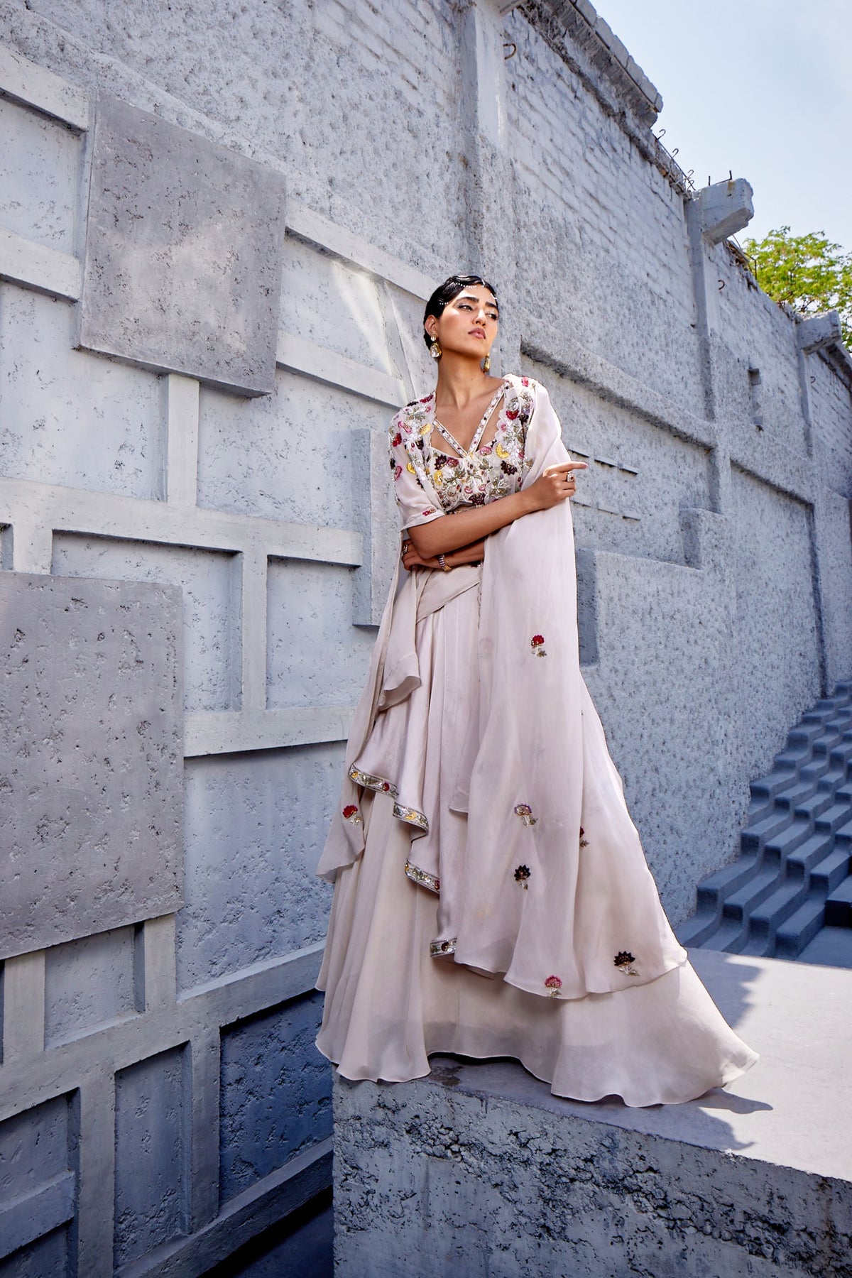 A corset blouse with straps embracing the neck paired with a flared skirt